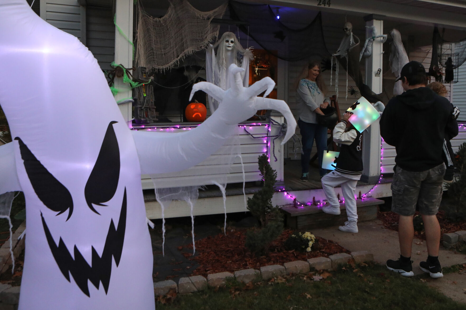 Joyce Flentke hands out candy from her porch